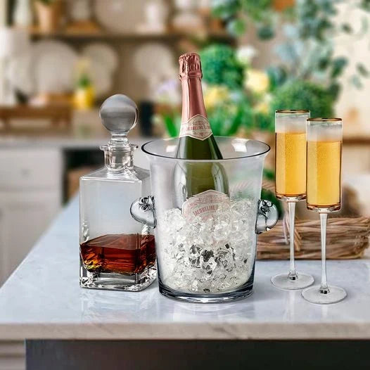 Creative Gifts Direct decanter, champagne bottle in an ice bucket, and two flutes arranged on a bright kitchen counter.