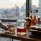 Round glass decanter, 50 oz, with a clear design and sturdy base for elegantly serving and displaying whiskey, brandy, and other spirits.

