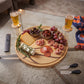 Pine wood basketball-shaped board measuring approximately 13 inches in diameter, featuring detailed basketball lines, natural wood grain, and grooved edges to help prevent spills.