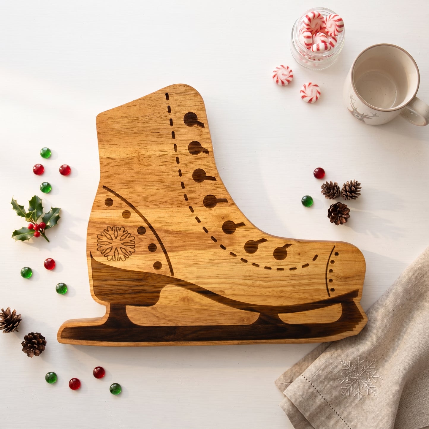 Ice skate-shaped wood serving board, 12.5 x 15 inches, made from pine wood with detailed laces, stitching, blade, and snowflake accent, ideal for winter gatherings.
