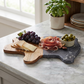 Black marble and acacia wood pig-shaped serving board, 8 x 11.75 inches, with a modern design for serving cheese, charcuterie, appetizers, and snacks.