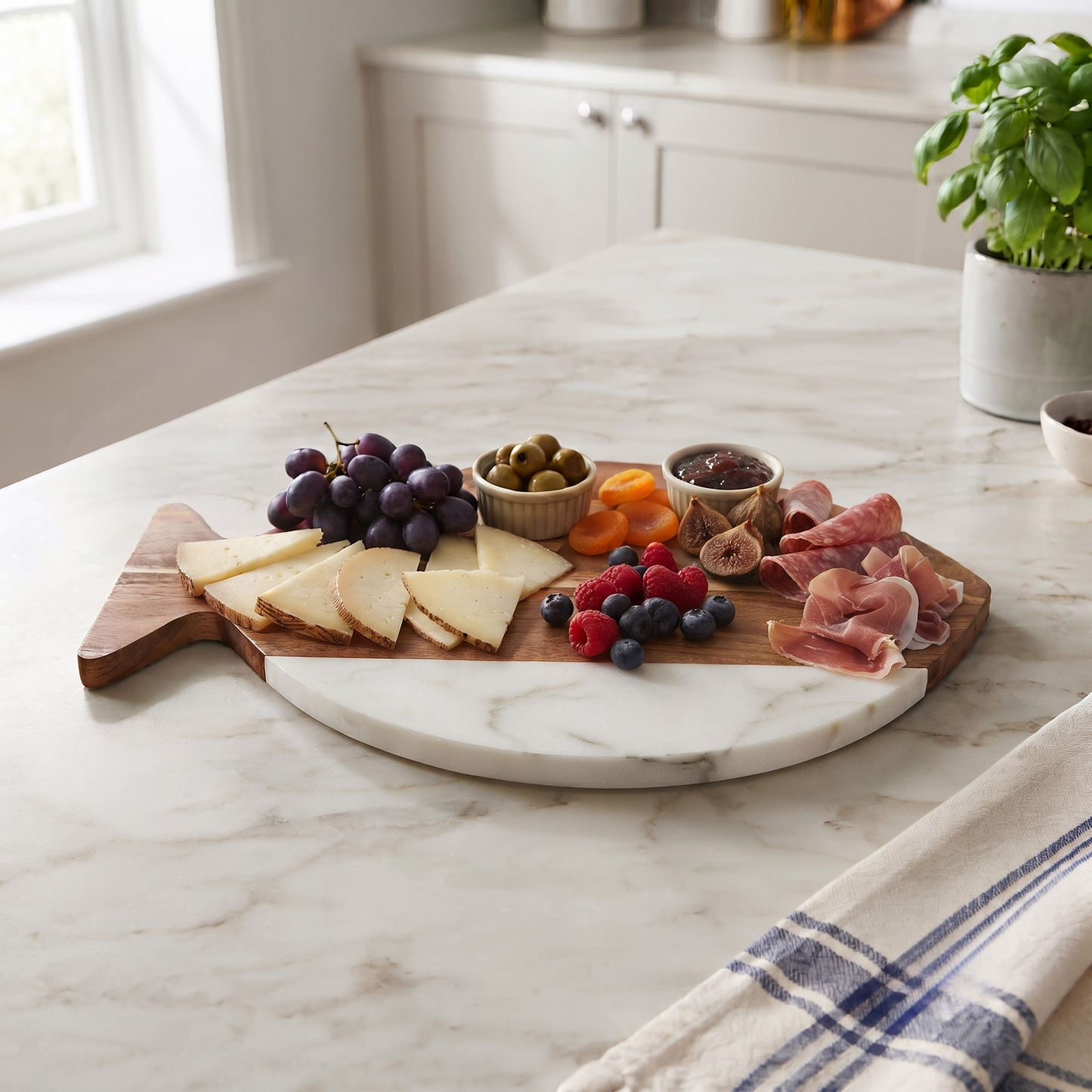 White marble and acacia wood fish-shaped serving board, 11.75 x 7.75 inches, with a black marble accent for serving cheese, charcuterie, appetizers, and snacks.