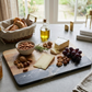 Black marble and acacia wood rectangle serving board, 11.75 x 8 inches, with a modern design for serving cheese, charcuterie, appetizers, and snacks.