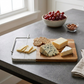 White marble and acacia wood cheese slicer board with stainless steel handle and cutting wire, 12.5 inch x 8 inch, ideal for serving cheese, charcuterie, bread, fruit, and appetizers.