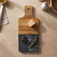 Black marble and acacia wood handled serving board, 15-inch by 6.25-inch, for charcuterie, appetizers, and entertaining.