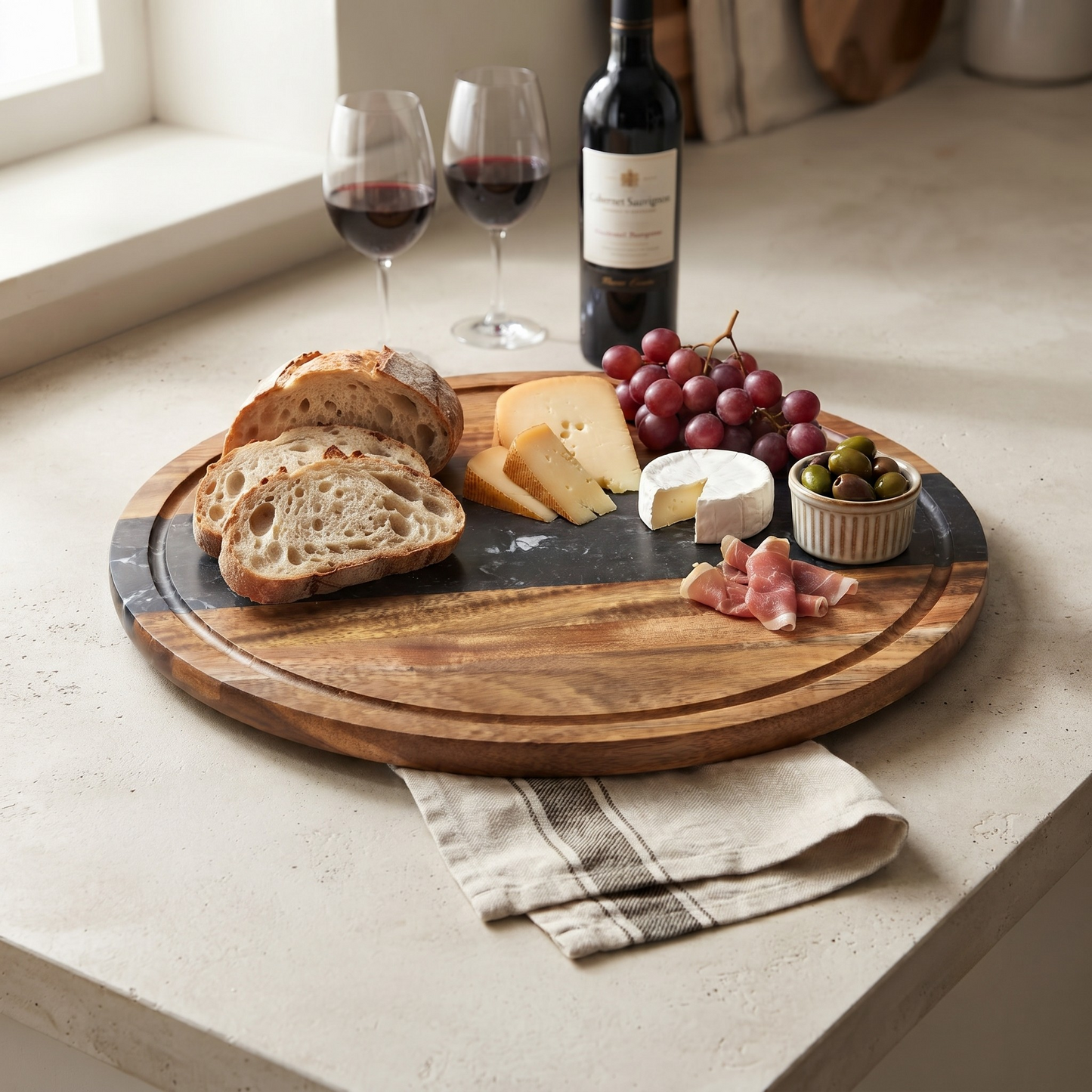 Black marble stripe and acacia wood round serving board, 11-inch diameter, for charcuterie, serving, and food prep.
