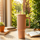 40 oz stainless steel insulated tumbler in Tan color with handle and removable straw, featuring a modern design for hot or cold beverages.