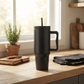 Black stainless steel tumbler with a 40 oz capacity, handle, and removable straw, featuring a sleek modern design and measuring 12 inch x 6.25 inch.