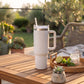 White 40 oz stainless steel tumbler with handle and straw, featuring an insulated design for keeping drinks hot or cold on the go.
