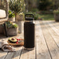 Black 36 oz stainless steel water bottle with twist-off cap, featuring a sleek reusable design for keeping drinks hot or cold throughout the day.
