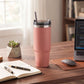 Peach 30 oz stainless steel tumbler with straw, featuring a compact handle-free design for keeping drinks hot or cold on the go.
