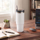 White 20 oz stainless steel tumbler with straw, featuring a compact design for keeping drinks hot or cold on the go.
