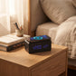 Black wireless phone charger and digital clock measuring approximately 7.28 x 3.43 x 3.35 inches, featuring an LED time, date, and temperature display, adjustable brightness, alarm settings, and a smooth bamboo design.