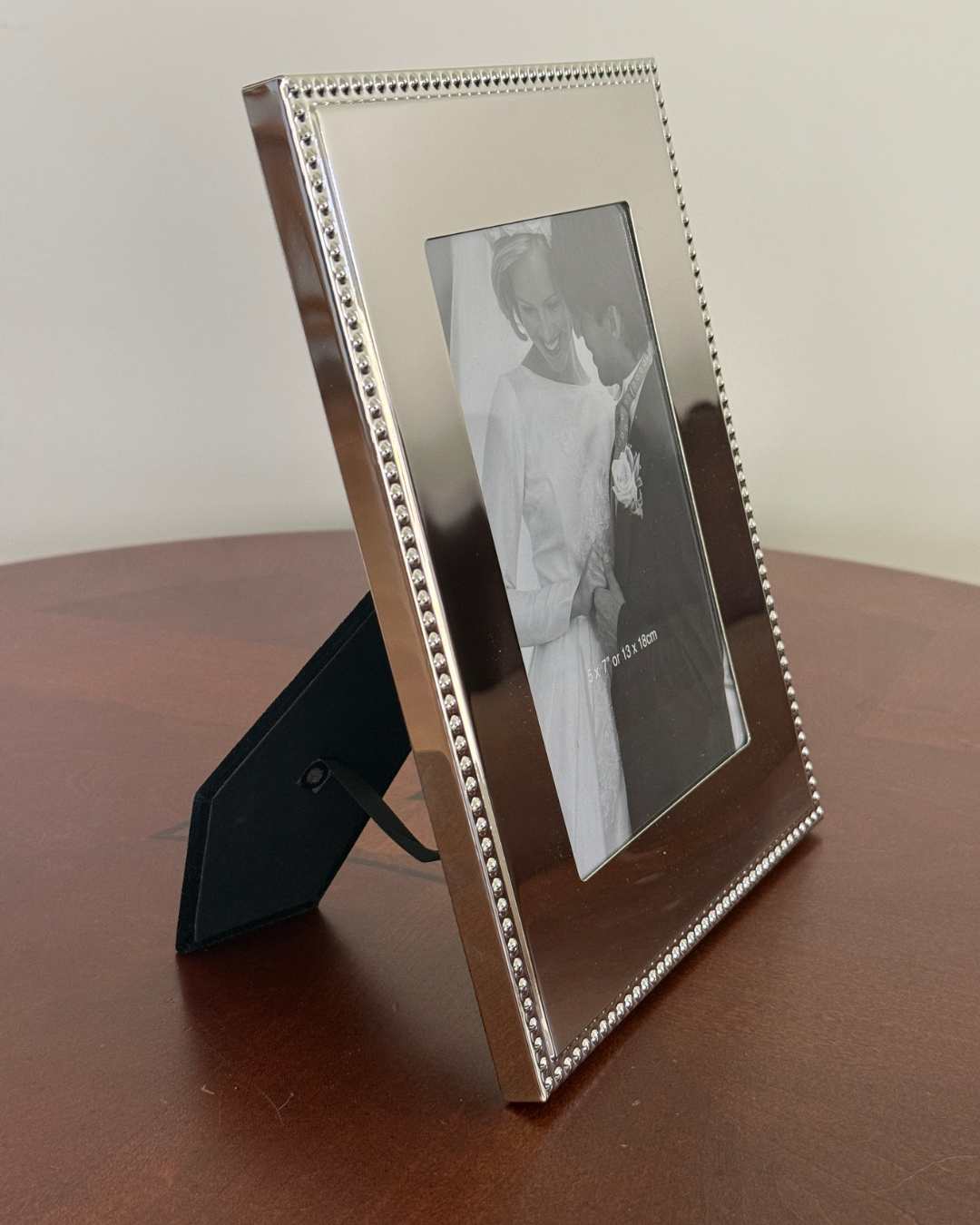 London 5 inch x 7 inch  photo frame featuring a bright metal finish and classic beaded edge, perfect for displaying treasured photos with timeless elegance.