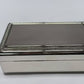 A shiny silver Rectangular Beaded Edge Lift-Top Jewelry Box with a smooth, reflective surface and beaded trim.