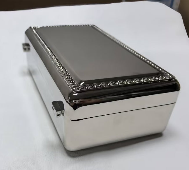 A sleek silver "Rectangular Beaded Edge Lift-Top Jewelry Box" from creativegiftsdirect, featuring a dark, reflective lid with beaded trim.