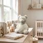 White ceramic teddy bear bank with glossy finish, 6 inch x 7 inch decorative coin bank for nurseries, kids' rooms, and baby shower gifts.