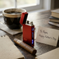 Red satin flameless flip-top lighter with dual arc technology, USB rechargeable design, windproof performance, and built-in safety features, making it a distinctive Father's Day gift.