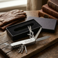 Folding 9-tool stainless steel pocket knife with scissors, corkscrew, saw blade, bottle opener, screwdrivers, and more, a versatile Father’s Day gift for outdoor enthusiasts and DIY dads.