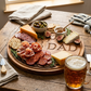 A 13-inch Golf ball-shaped wood charcuterie board engraved with "DAD," a unique Father's Day gift idea for golf-loving dads, ideal for entertaining and serving snacks.