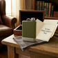 Green stainless steel flask with a silver bottom, 8 oz capacity, integrated lanyard cap, and durable corrosion-resistant construction, making it a thoughtful Father's Day gift for camping, hiking, and outdoor enthusiasts.