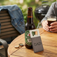 Grey leatherette and stainless steel bottle opener with a sleek design, black engraving option, and gift box packaging, making it a useful Father's Day gift.