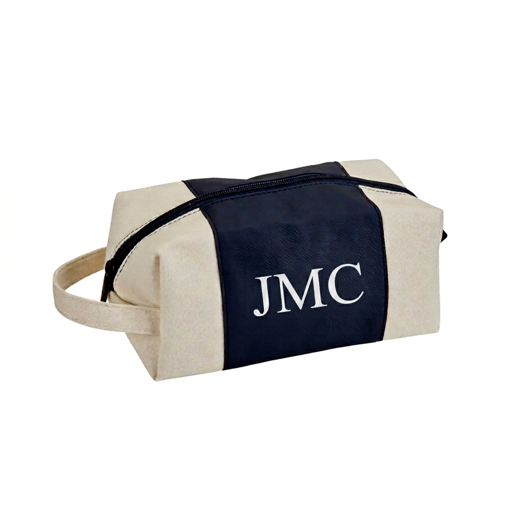 Navy leatherette and canvas travel kit with a classic Dopp kit design, zipper closure, and handle, perfect for organizing toiletries and grooming essentials. 