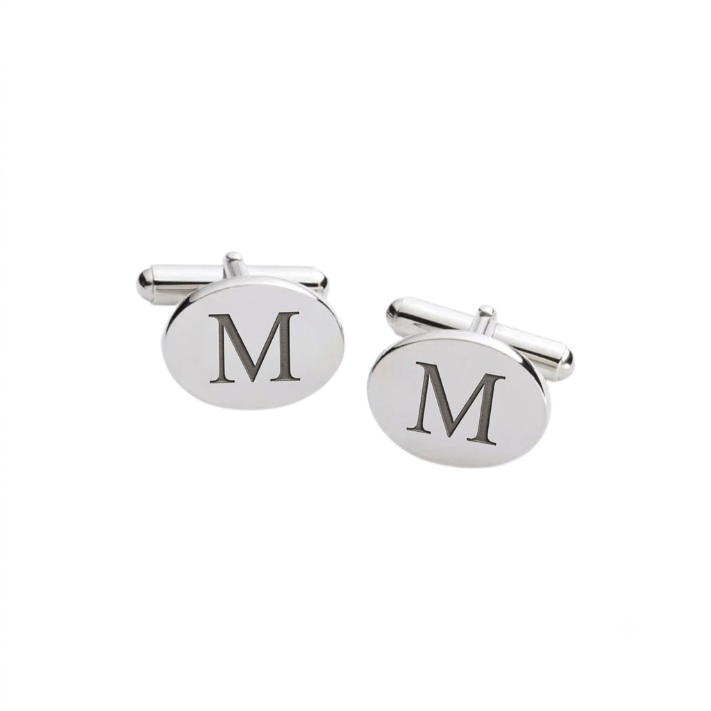Palladium-finish oval cuff links with a non-tarnishing polished surface, measuring 0.75" x 0.875" each. The engravable cuff links are presented in an elegant black gift box, ideal for personalized gifting and formal occasions.