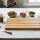 American Flag-shaped acacia wood serving board in a natural brown finish, designed for charcuterie, cheese, fruit, or appetizers, and suitable for personalization as a unique gift.