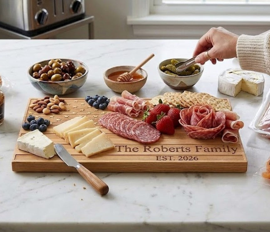 Engraved American Flag-shaped acacia wood serving board in a natural brown finish, designed for charcuterie, cheese, fruit, or appetizers, and suitable for personalization as a unique gift.
