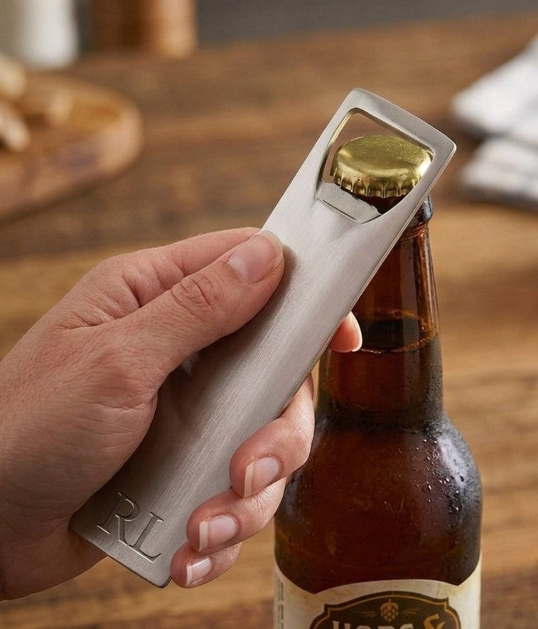 Stainless steel bottle opener with a sleek, slim design and engravable surface. Measures 4.96 inch x 1.13 inch, ideal for home bars, kitchens, weddings, groomsmen gifts, and personalized keepsakes.